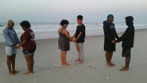NCCU Wesley Fellows praying together - Emerald Isle, NC